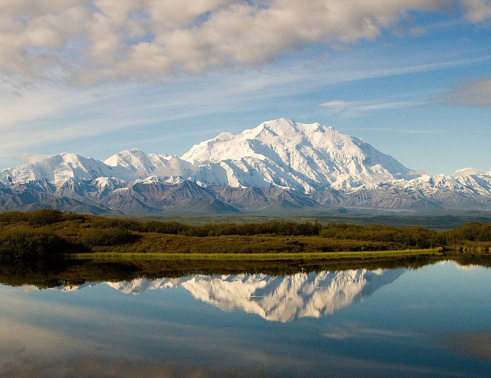 Snow-covered Denali rising above Wonder Lake in Alaska