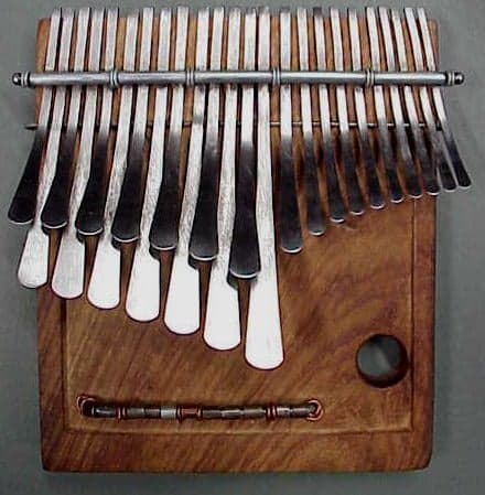 A traditional Zimbabwean mbira instrument with metal tines on a wooden board